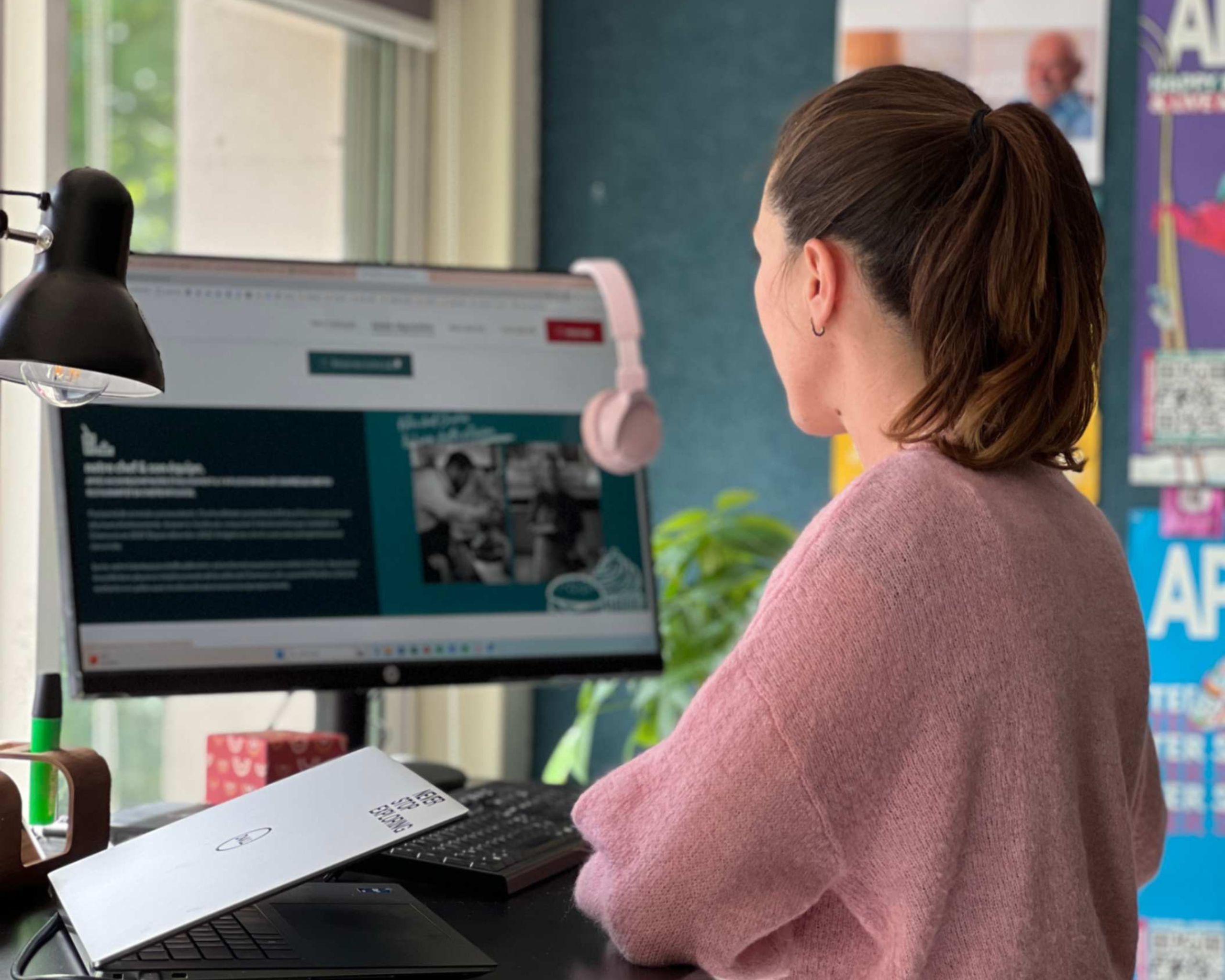 Employee standing at a desk in front of a computer